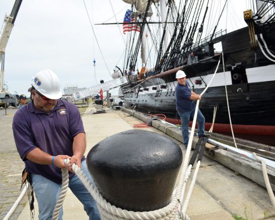 Members of the Naval History and Heritage Command secure the USS Constitution to the pier after Sunday's demonstration.