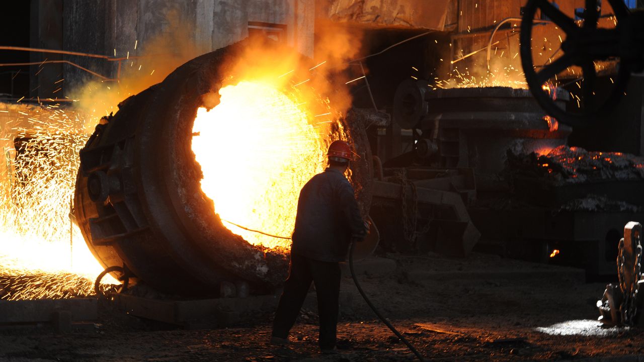 This photo taken on June 25, 2011 shows a worker stoking a giant burning cauldron at a steel mill in Hefei, China.