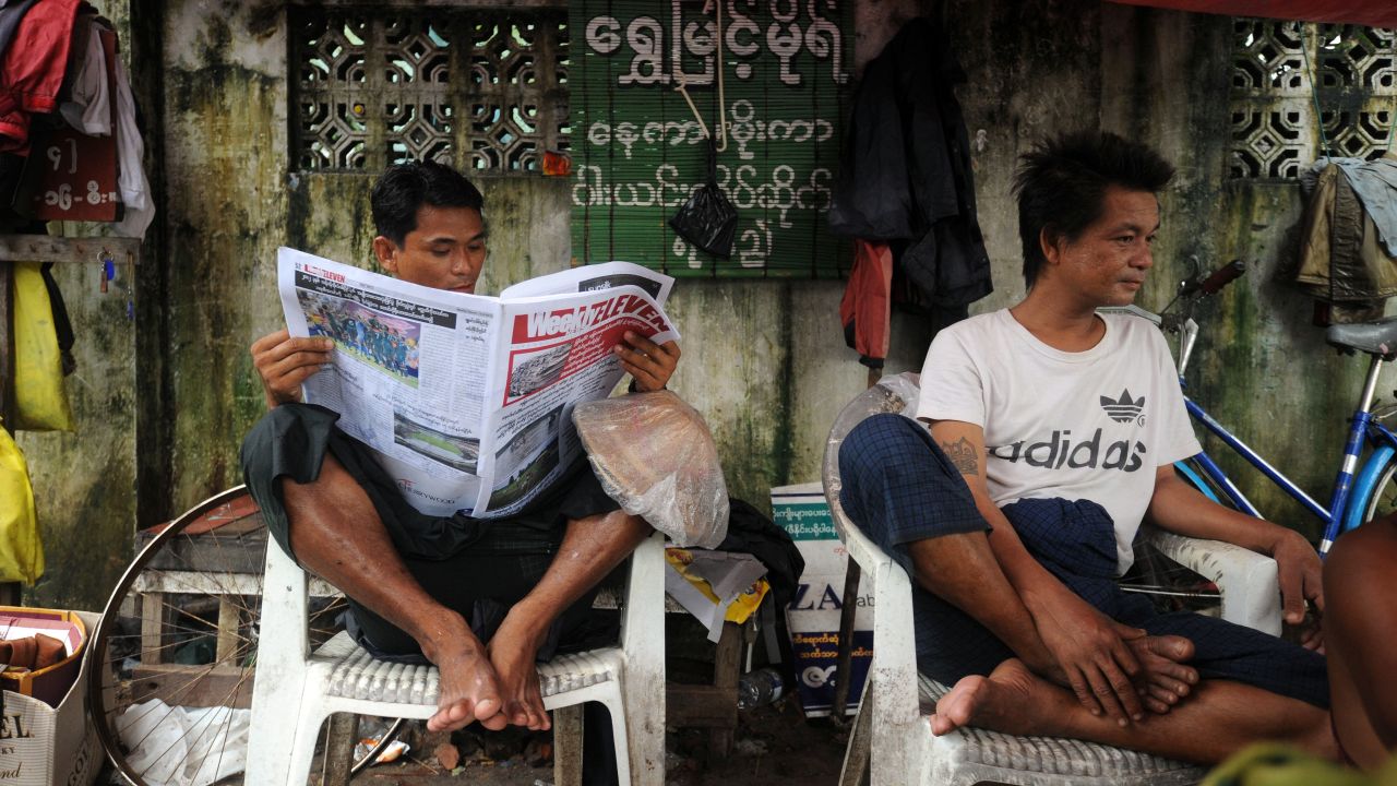 A man reads a local journal in Yangon on Monday. 