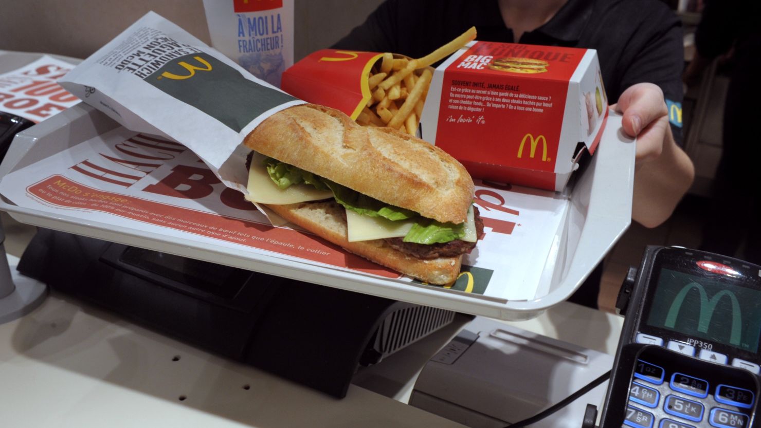 An employee displays the McBaguette, a burger-filled sandwich tested earlier this year at McDonald's restaurants in France.