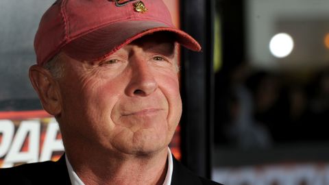 Director Tony Scott arrives at the October 2010 premiere of  "Unstoppable" wearing his trademark faded red baseball cap.