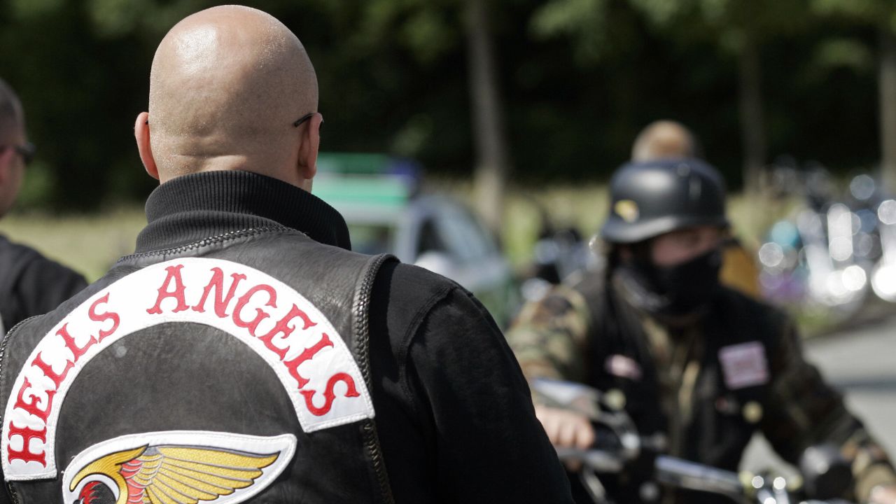 A man wearing a Hells Angels jacket looks on in 2007 as other motorcyclists arrive at a shop in Ibbenbuehren, Germany.