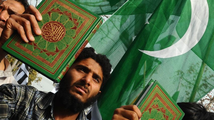 Deaf Pakistani men carry the Koran and placards during a protest in Lahore on March 18, 2012.