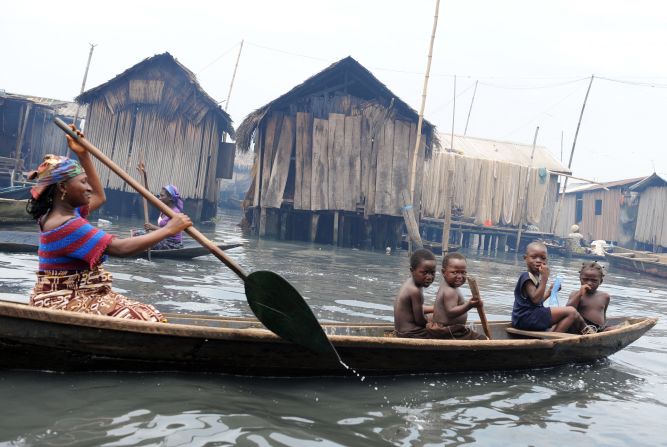 A mother paddles her canoe through a waterway in Makoko. The population explosion in Lagos has resulted to unprecedented demand for land. 