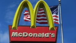 A sign for a McDonald's restaurant sits in front of an American Flag July 23, 2012 in Miami, Florida. The company announced that 2nd quarter profit dropped 4.5 percent. (Photo by Joe Raedle/Getty Images)