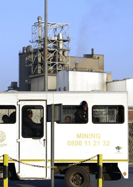 Miners arrive at the Marikana mine on  August 21 after owners Lonmin gave striking workers until 0500 GMT to return to their jobs or face dismissal. 