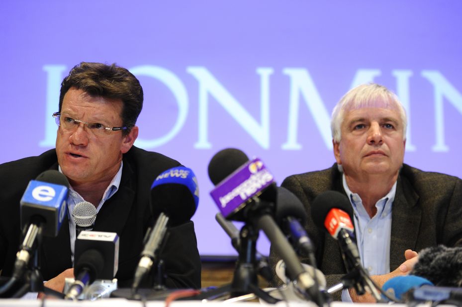 Mark Munroe (left), executive vice president for mining at Lonmin, sits alongside the company's chief financial officer Simon Scott during a press conference  in Marikana on August 20. 