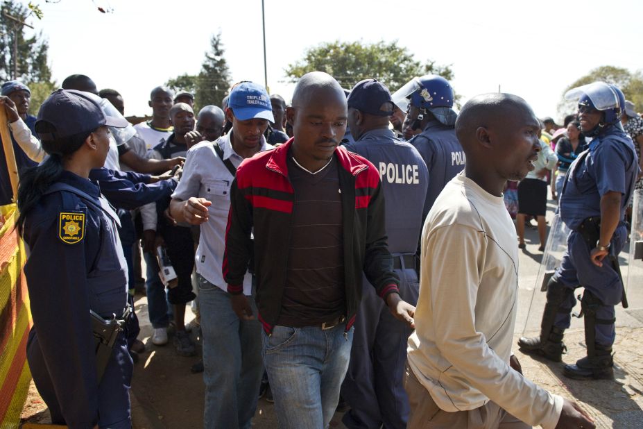 Miners arrested for allegedly being involved in violent clashes between striking workers and police are escorted from the Ga-Rankuwa courthouse, Pretoria, on August 20. 