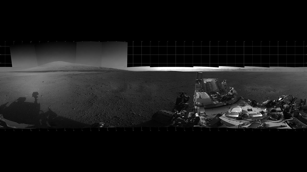With the addition of four high-resolution Navigation Camera, or Navcam, images, taken on August 18, 2012. Curiosity's 360-degree landing-site panorama now includes the highest point on "Mount Sharp" visible from the rover. Mount Sharp's peak is obscured from the rover's landing site by this highest visible point. 