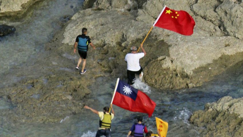 Activists walk on an island claimed by both Japan and China in the East China Sea on August 15.