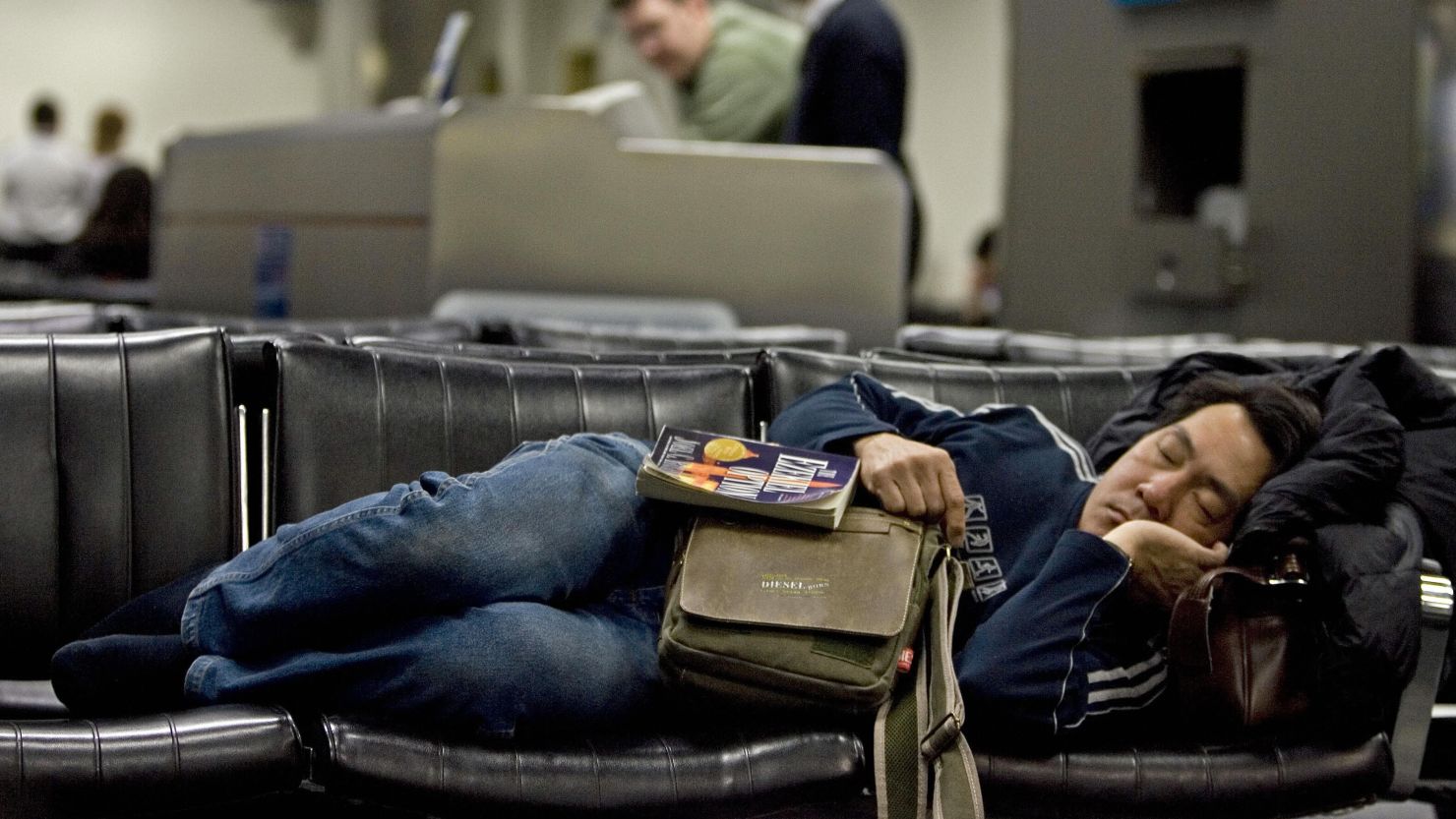 Standby passengers often resort to sleeping in airports while waiting for an open seat on a flight.