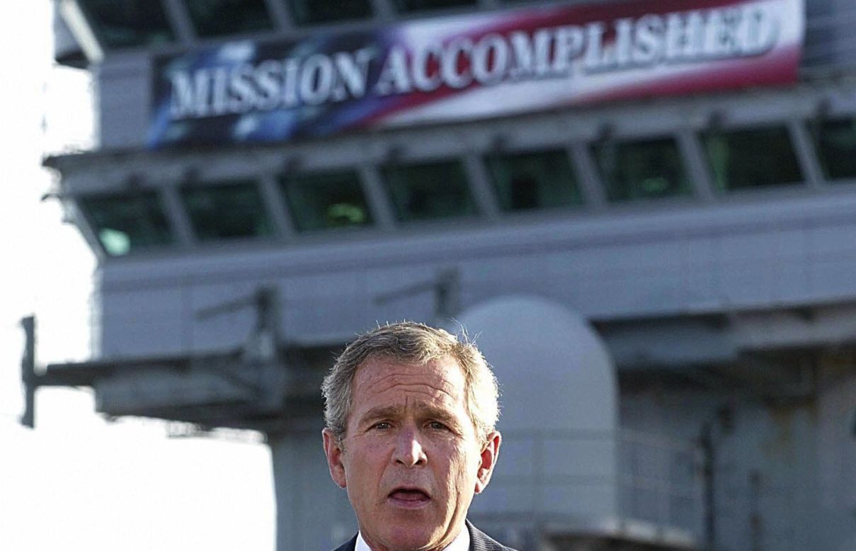 <strong>PROMISE: "Mission Accomplished."</strong> The banner aboard the USS Abraham Lincoln heralded Bush's announcement of an end to major combat operations in Iraq just months after the invasion. The fighting, however, would drag on for seven years.