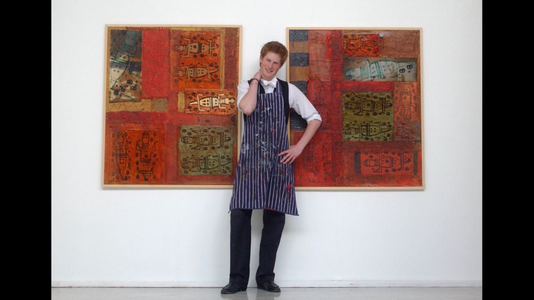 In 2003, Harry stands between some artwork he completed while studying at Eton College.