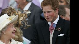 Britain's Queen Elizabeth II and Prince Harry share a joke as they watch Prince Charles and his bride Camilla Duchess of Cornwall leave St George's Chapel in Windsor, England following their marriage blessing on April 9, 2005.