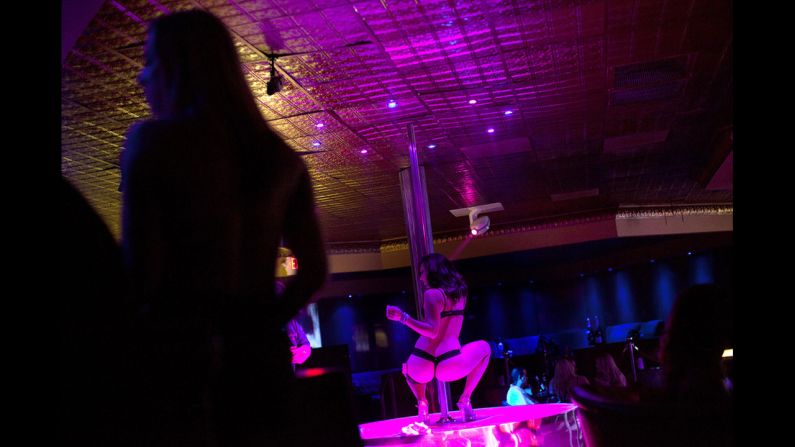A dancer works a pole at Thee DollHouse.