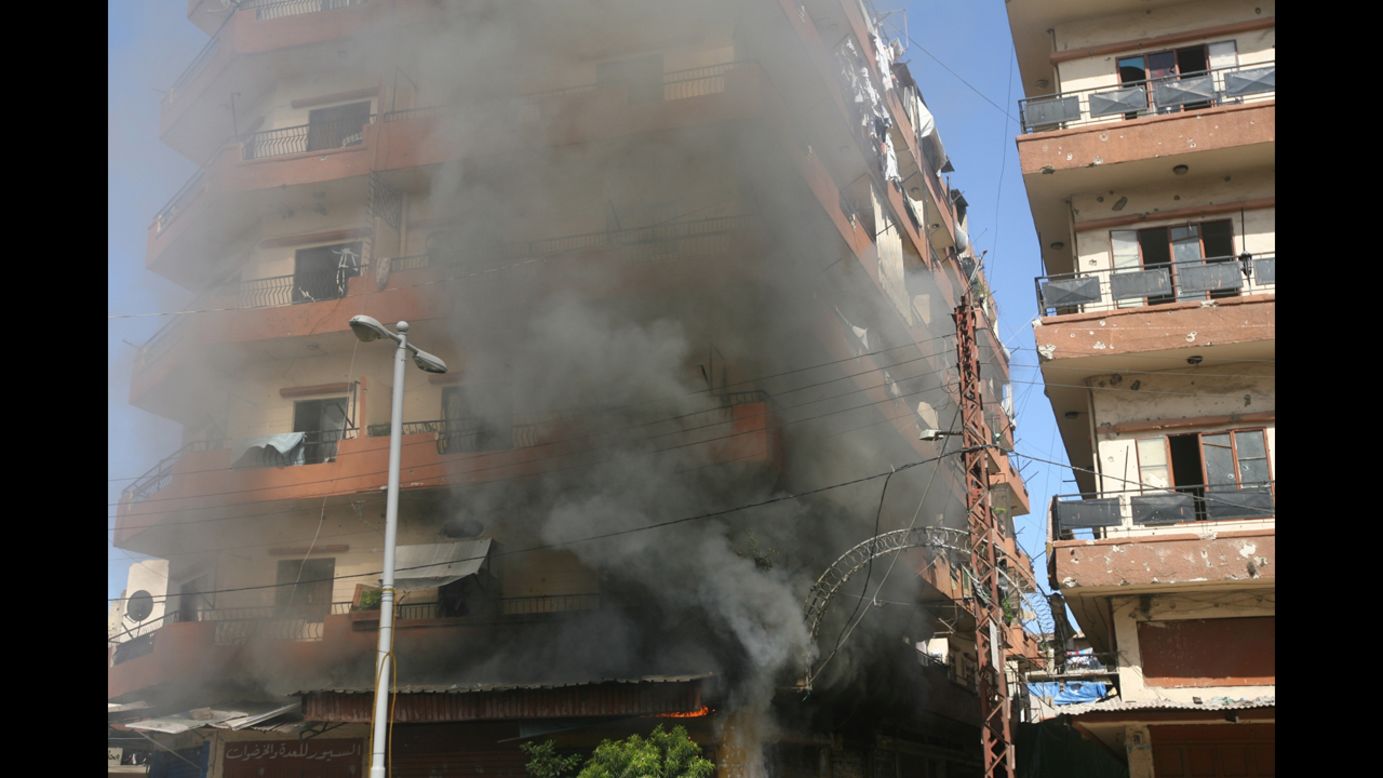 Smoke billows from a building in Tripoli's Bab al Tabaneh area Tuesday following fighting between the two groups. Resentment from the nearly 30-year Syrian occupation still lingers in Lebanon, which struggles to maintain a balance among its religious and ethnic sects. 