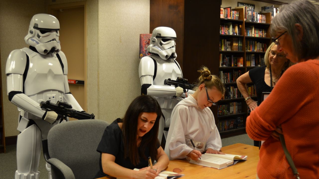"Bullied" author Carrie Goldman signs copies of her books with daughter Katie.