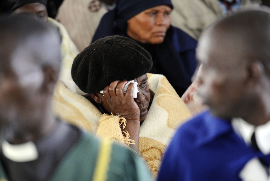 A woman mourns during a memorial service for the 44 people killed at Lonmin's Marikana mine on Thursday. 