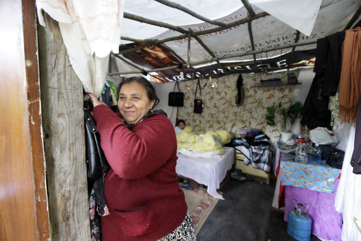 A woman from the Roma community at the entrance of a shack in a camp in Evry.