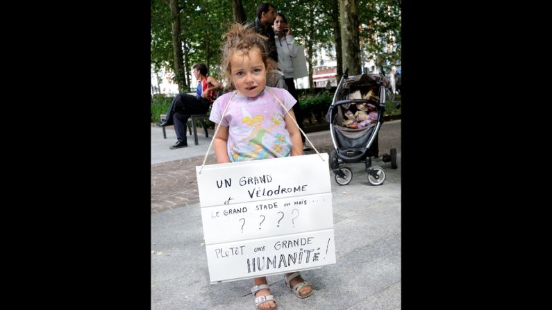 A child holds a placard during a demonstration in support of the Roma people.
