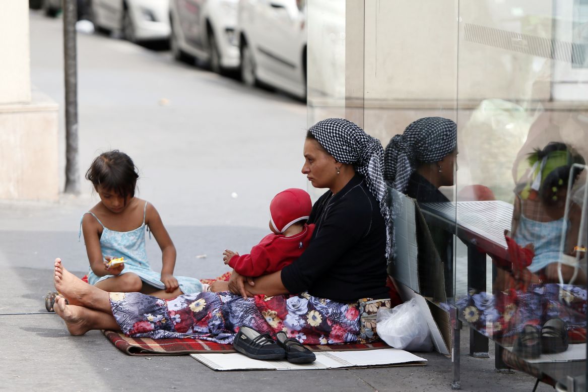 A Roma woman and her children beg at the Place de la Bastille in Paris on Wednesday, August 22.