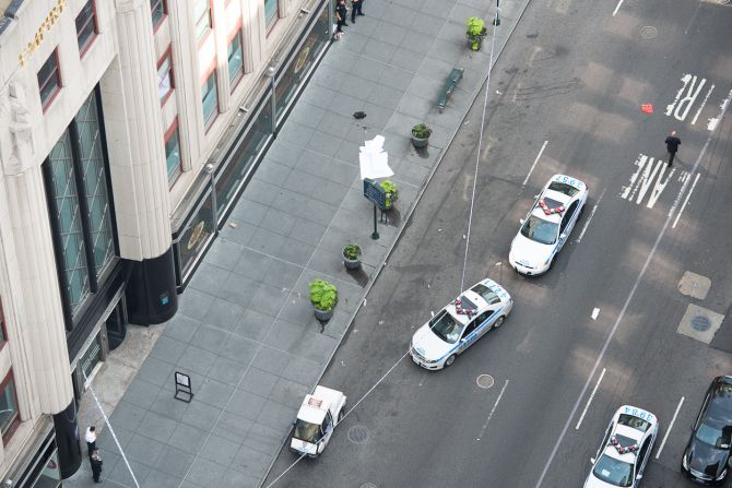 Vladimir Dusio, an iReporter who says he lives across the street from the Empire State Building, photographed police at the scene Friday.