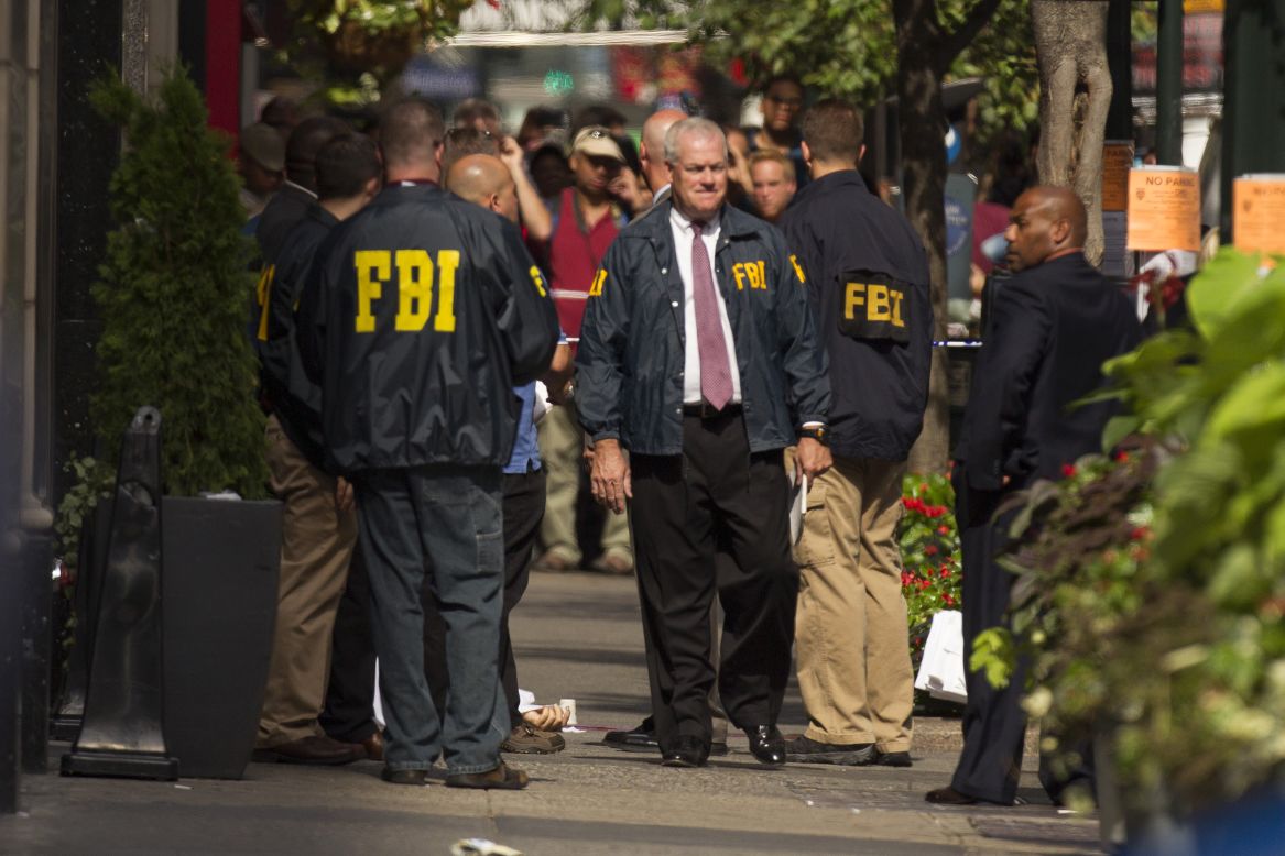 FBI authorities gather near a body outside the Empire State Building.