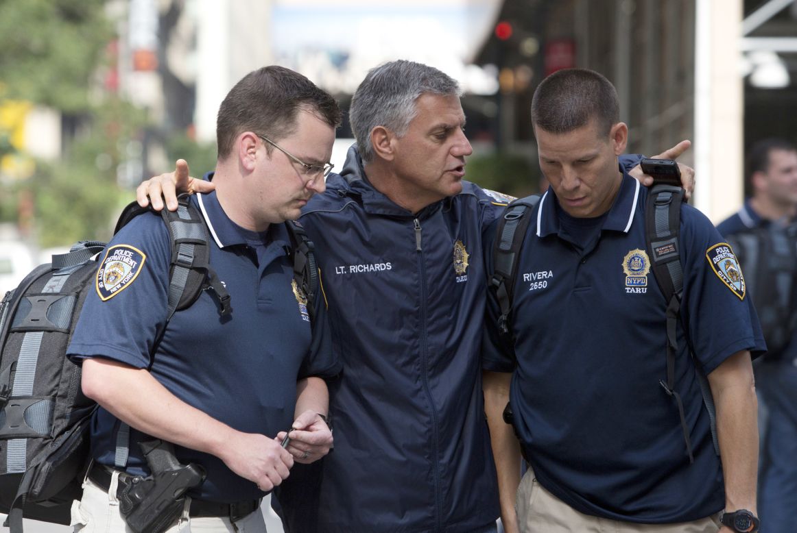New York police confer at the shooting scene. 