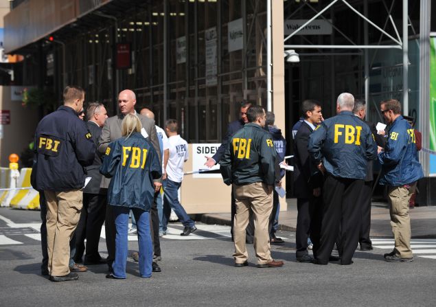 FBI agents gather at the scene, which some witnesses said sparked memories of the 2001 terrorist attacks. Authorities said the shooting was not related to terrorism.