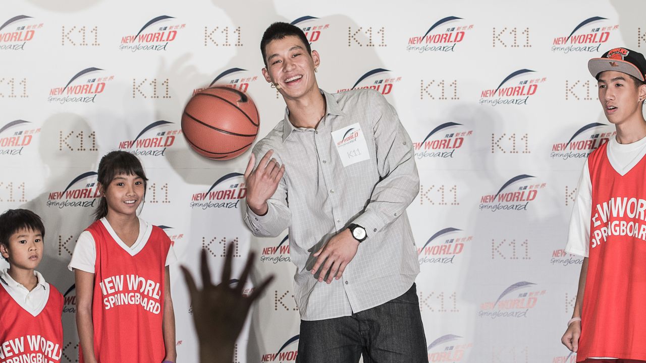 Jeremy Lin tosses a basketball during a promotional event in Hong Kong. 