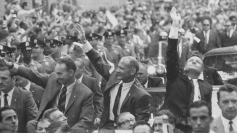 Apollo 11 astronauts Neil Armstrong, Buzz Aldrin and Michael Collins waving to crowds at a parade celebrating their return from the moon. 