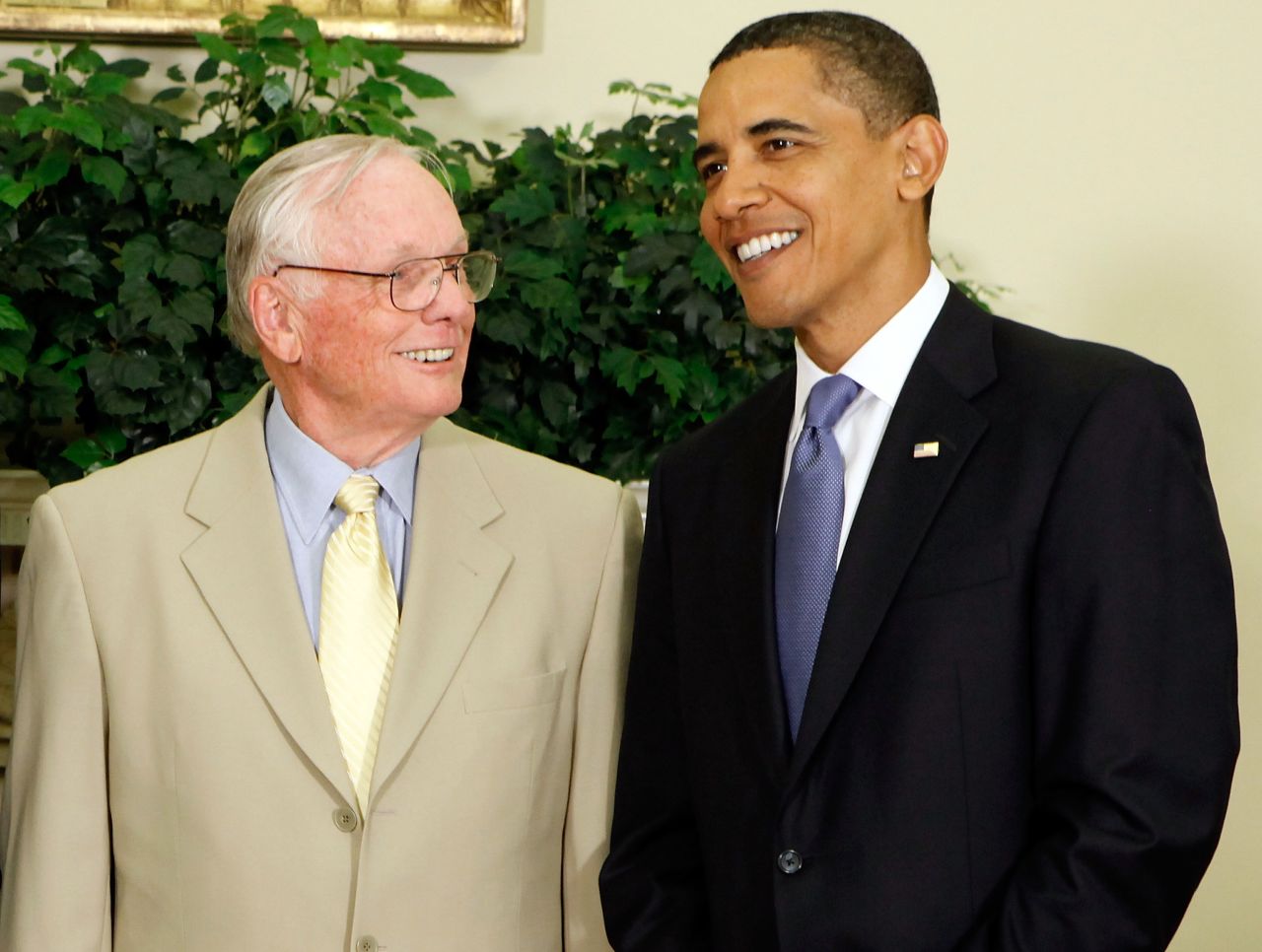 President Barack Obama poses for photographs with Armstrong in the Oval Office at the White House in 2009.