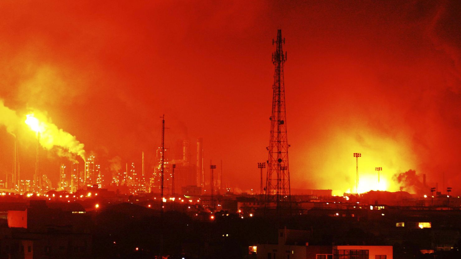Fire glows at the site of an explosion at Amuay oil refinery in Punto Fijo, Venezuela, on Saturday.