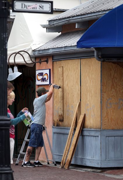 A Florida Keys resident boards up the windows of a store on Duval Street in Key West after a hurricane warning was issued ahead of Tropical Storm Isaac.