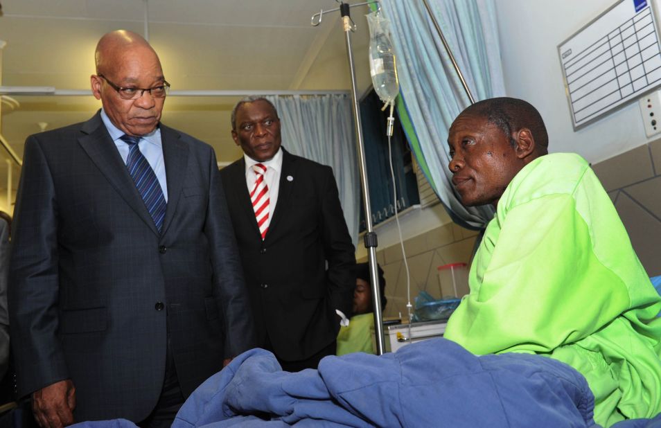 Miner Mfaseni Yekwayo, at a hospital near Rustenburg on August 18, relates to South African President Jacob Zuma, left, the events leading to the miners' clash with police.