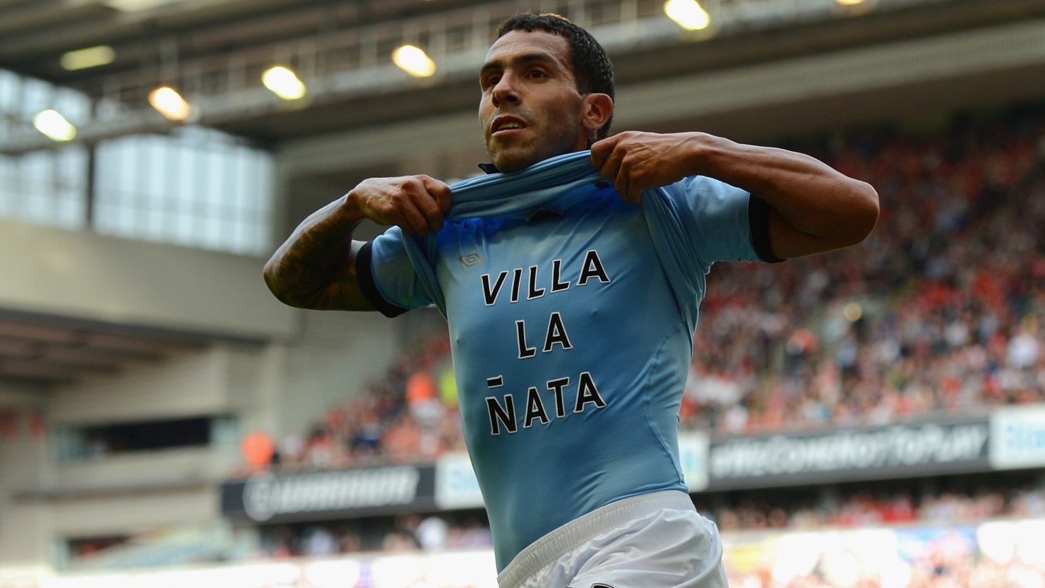 Carlos Tevez celebrates his equalizer at Anfield in Manchester City's 2-2 draw with Liverpool.