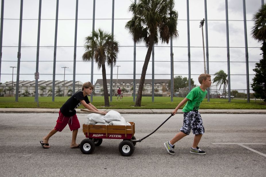 Andrew Marino, left, and Colby Collier pull a wagon filled with sandbags back to their homes as Florida residents prepared for Tropical Storm Isaac in St. Pete Beach, Florida, on Sunday.