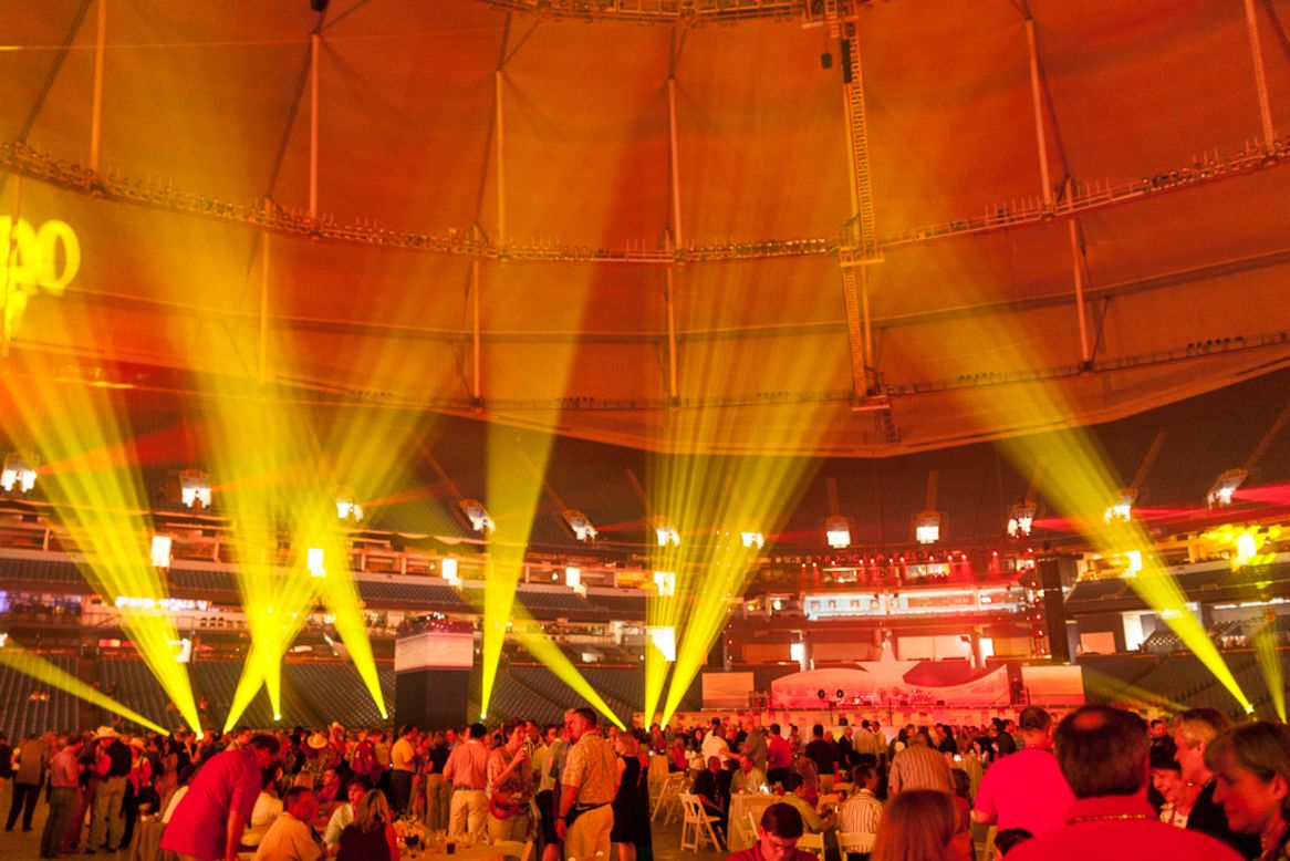 Convention-goers gather at Tropicana Field for a convention opening party Sunday night.