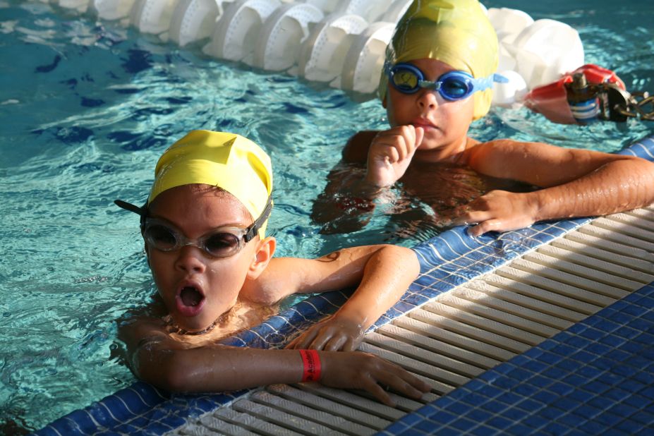 Two junior participants take a mini-break halfway through their swim portion. 