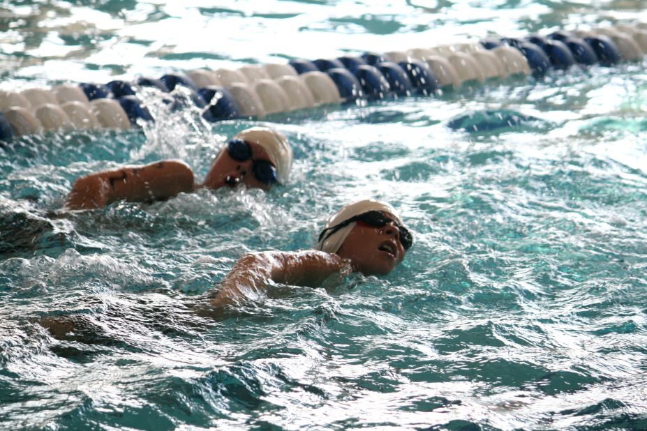 Two senior boys race it out at the end of their 200-yard swim. 