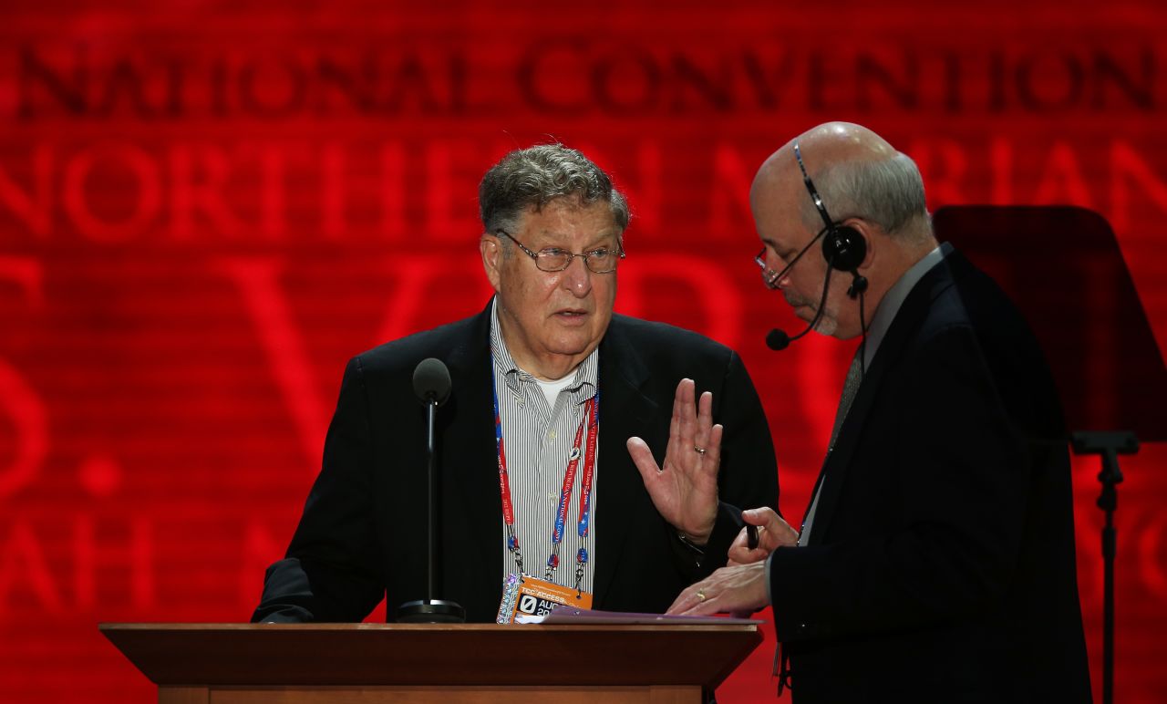 Former New Hampshire Gov. John Sununu, left, stands at the podium with stage manager Howard Kolins before events begin Monday.