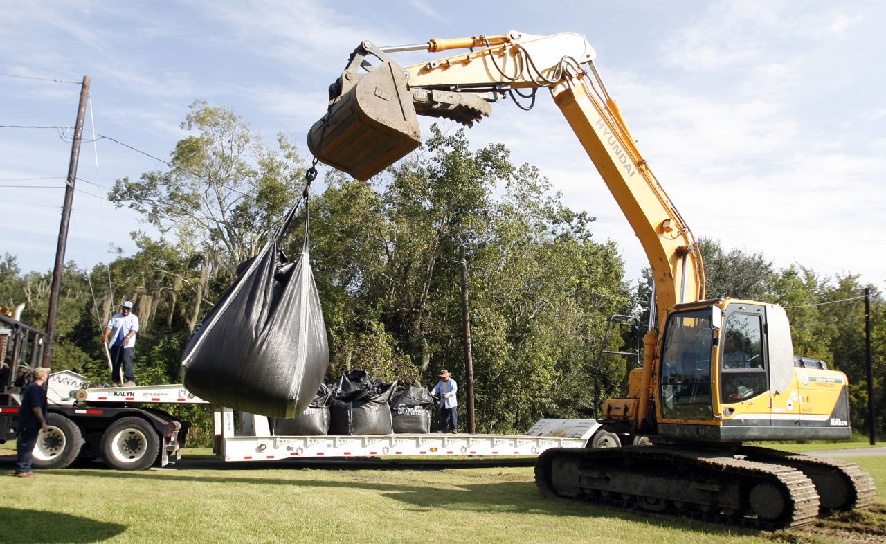 A crew from Jefferson Parish Drainage Department places large sandbags near a canal and pond in Jean Lafitte, Louisiana, on Monday in preparation for Isaac. 