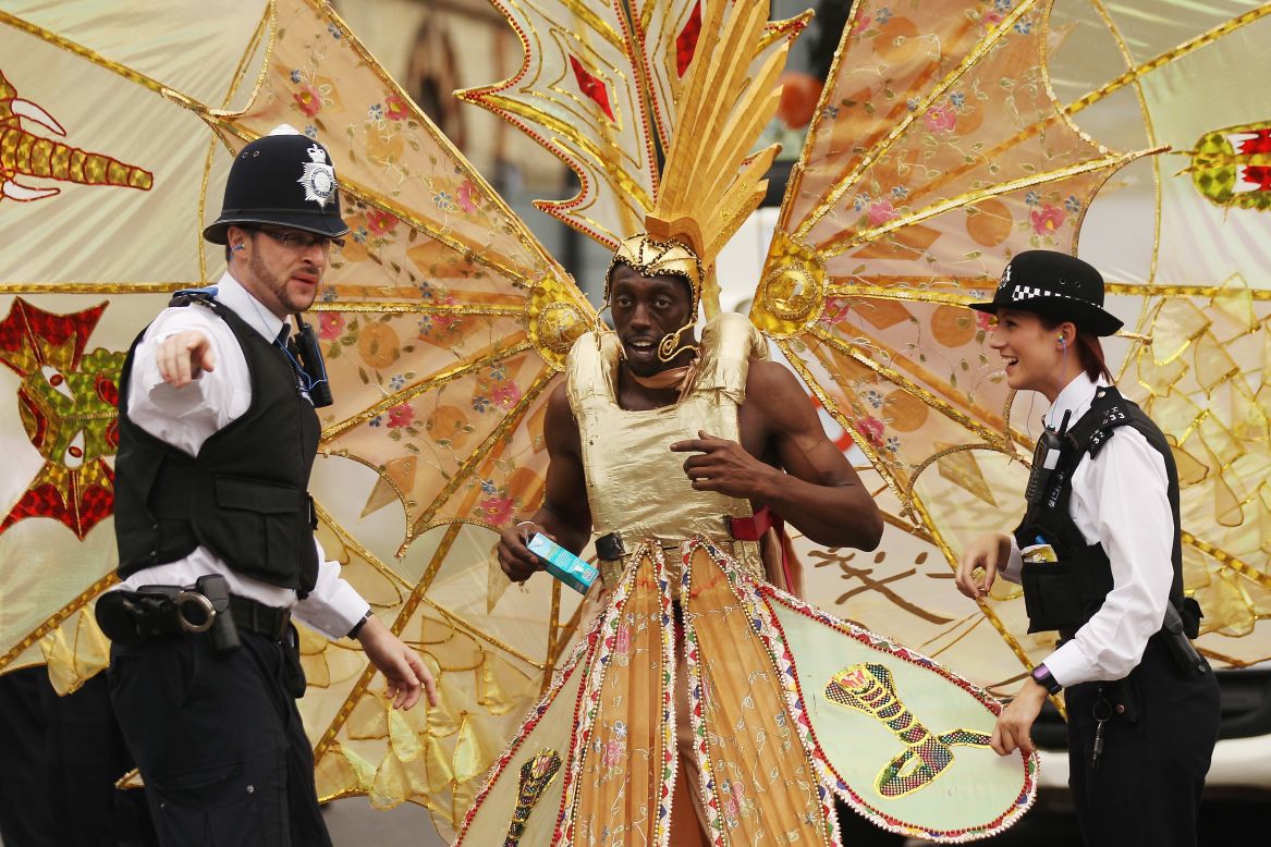 Police officers direct a participant at the Notting Hill Carnival in London on Monday, August 27. The annual two-day festival is billed as the largest of its kind in Europe and is expected to attract around 1 million revelers. It has taken place every  August bank holiday since 1966.