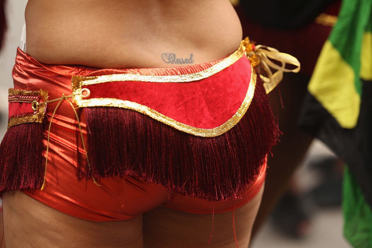 A dancer with "Blessed" tattooed on her lower back performs.