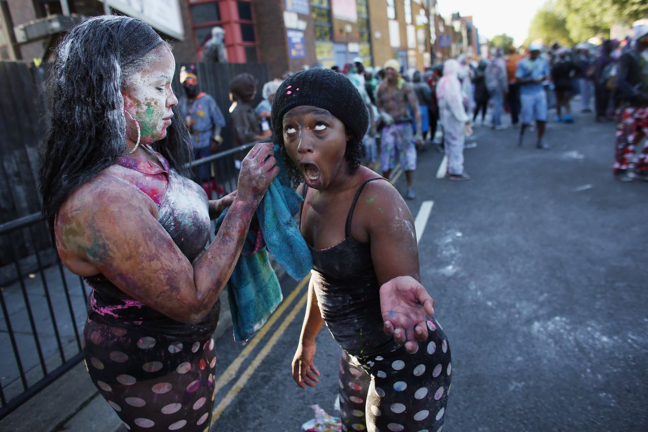 Carnival-goers cover each other in paint and flour on Sunday.