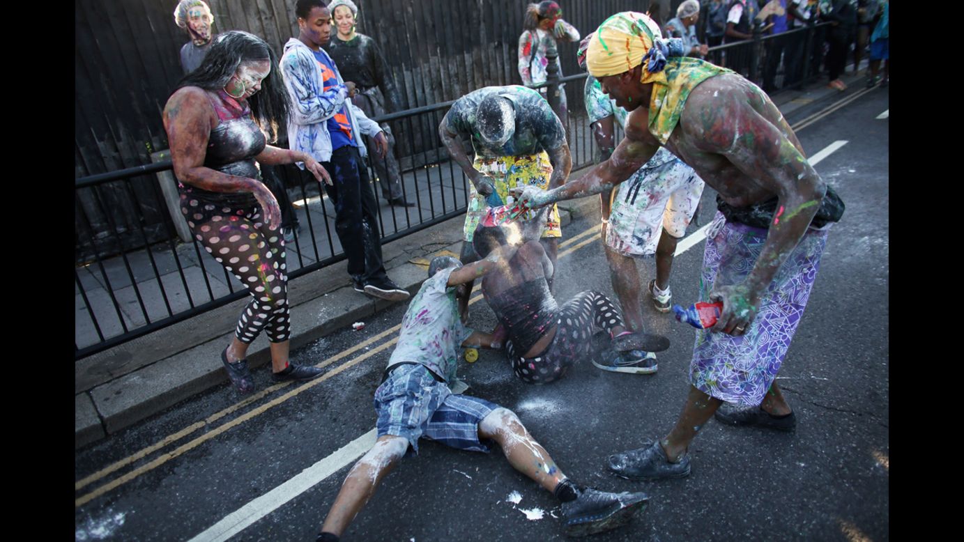 People covered in paint attend the carnival on Sunday.
