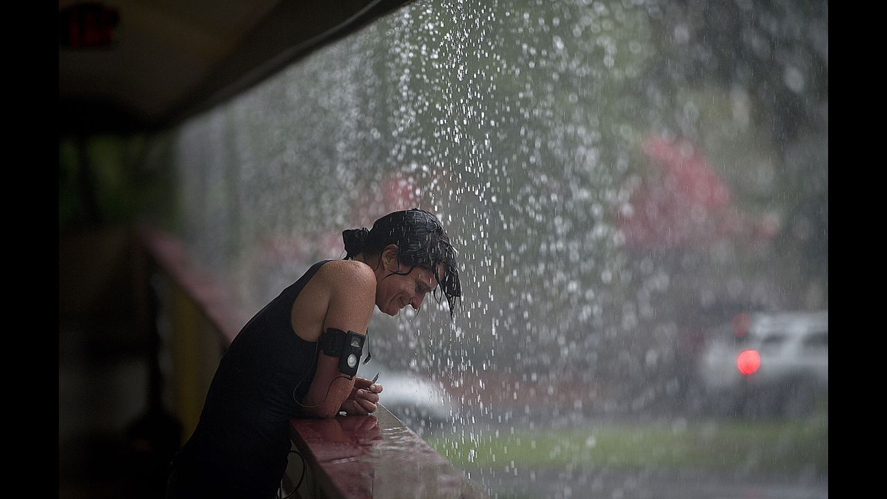 A woman enjoys the a heavy rain in the Tampa, Florida, area, on Monday. Hurricane Isaac is expected to make landfall near New Orleans.