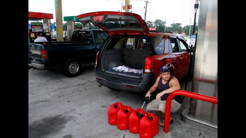 Ocean Springs, Mississippi, resident Charles Bartlett fills several gas containers in preparation for Isaac.