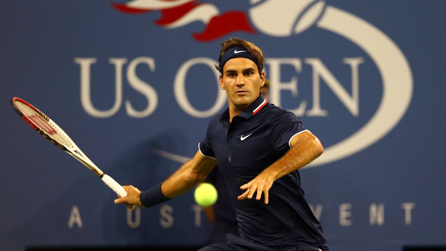 Roger Federer sends the ball back during a winning first set against Donald Young in their first round match.