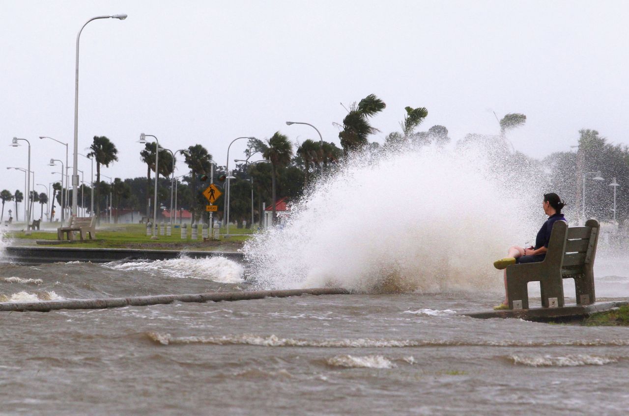 Diana Whipple of New Orleans watches waves crash on the shore of Lake Pontchartrain as Hurricane Isaac approaches Tuesday. Isaac became a Category 1 hurricane Tuesday when its maximum sustained winds reached 75 mph, the National Hurricane Center says.
